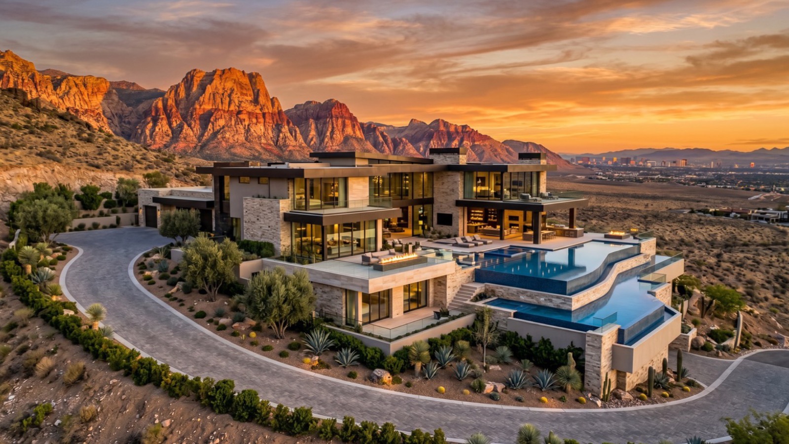 Aerial view of a modern hillside luxury estate near Red Rock Canyon in upper Summerlin at twilight