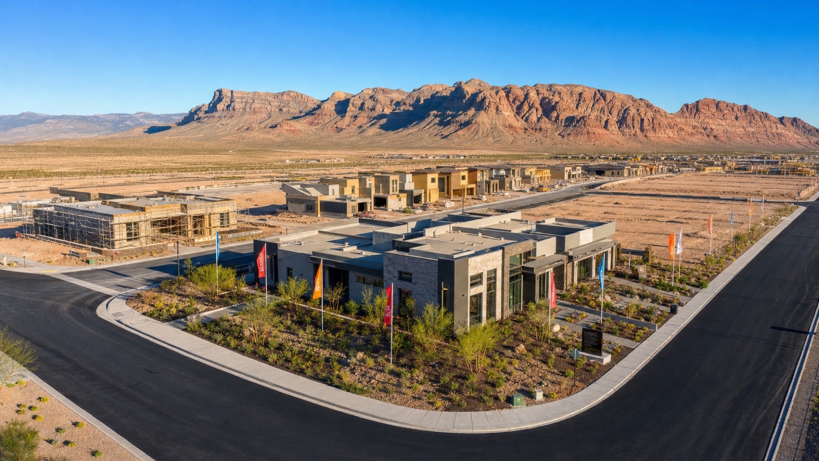 Aerial view of graded superpads and newly framed homes in Summerlin West with the Spring Mountains in the background