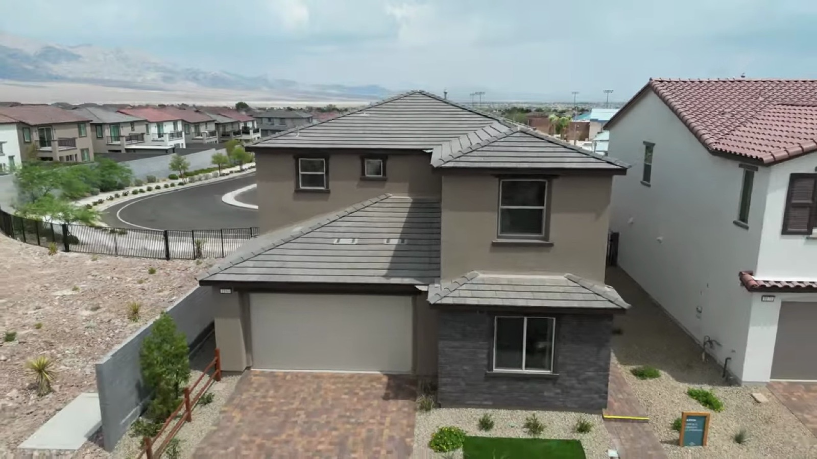 Aerial view of the Woodside Oakley model at Lyra at Sunstone in Northwest Las Vegas with its two-car garage and stone-accented front